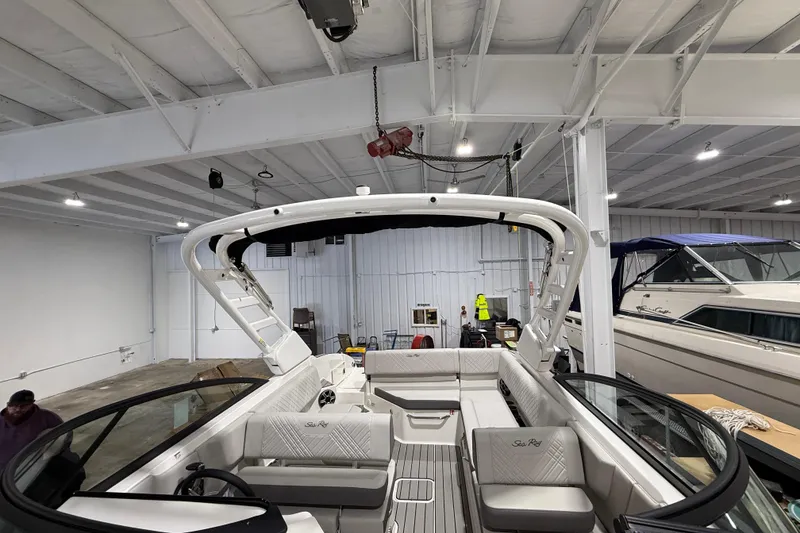 Slide: The Image of 2026 Sea Ray SDX 270 boat interior in a spacious indoor showroom. - 22