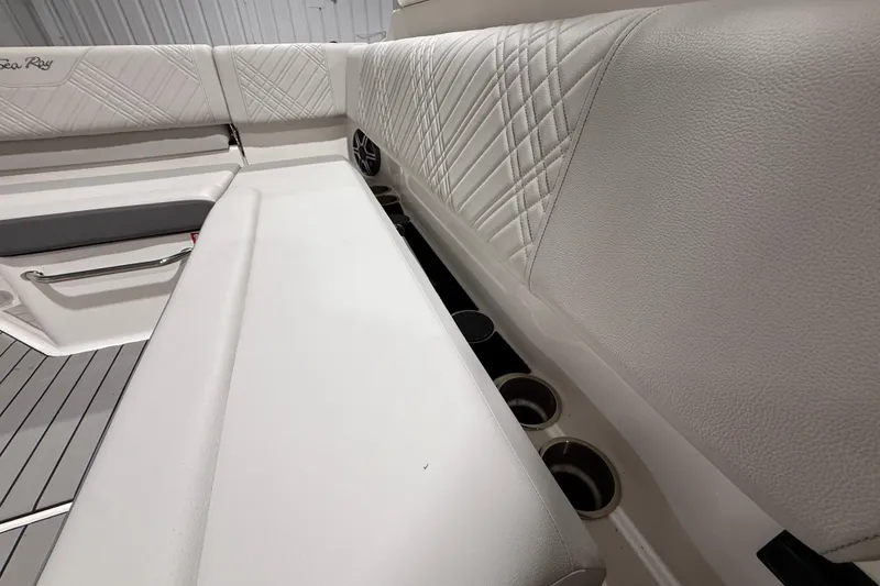 Slide: The Image of 2026 Sea Ray SDX 270 boat interior with white leather seating and cup holders. - 23