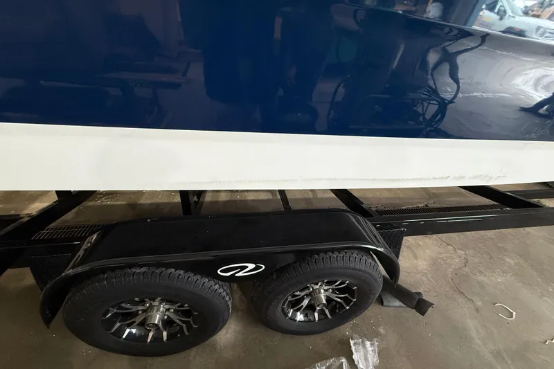 Slide: The Image of 2026 Sea Ray SDX 270 boat on trailer, showcasing sleek blue hull design. - 24