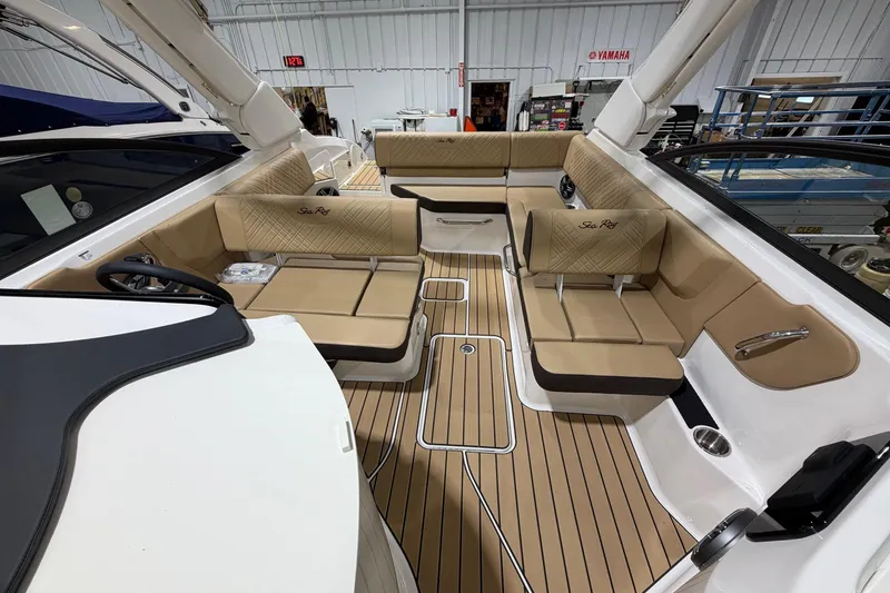 Slide: The Image of Luxurious interior of 2026 Sea Ray SDX 250 boat with tan seating and wood flooring. - 13