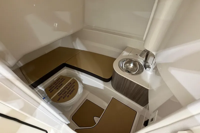 Slide: The Image of 2026 Sea Ray SDX 250 boat interior with compact sink and toilet. - 14