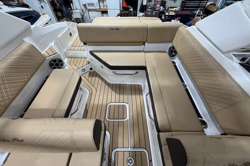 Slide: The Image of Luxurious interior of 2026 Sea Ray SDX 250 boat with tan seating and wood flooring. - 9