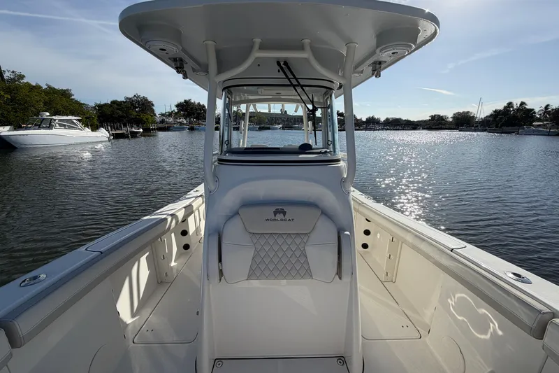 Slide: The Image of 2025 World Cat 295 CC boat on calm water, showcasing sleek design and spacious deck. - 18