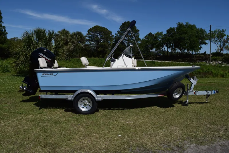 Slide: The Image of 2026 Boston Whaler 170 Montauk boat on trailer outdoors. - 0