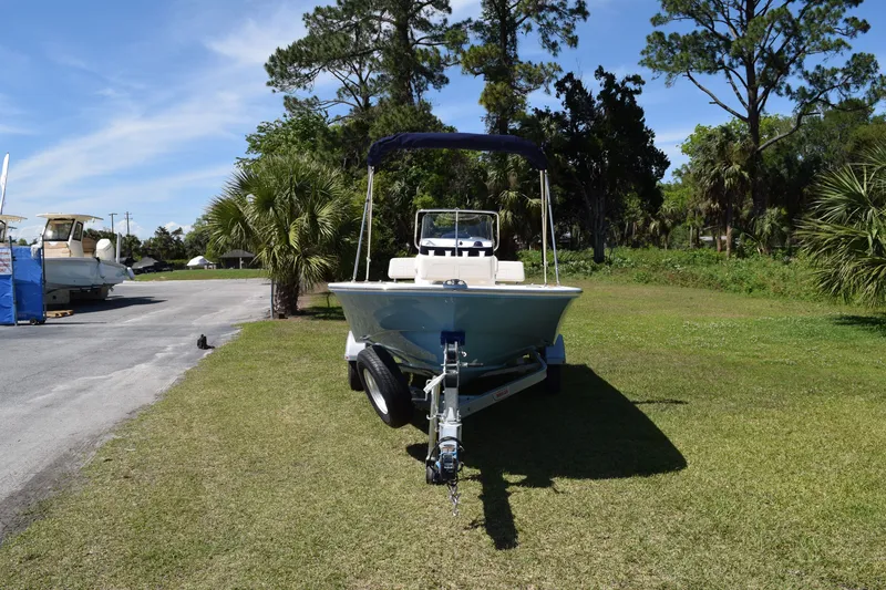 Slide: The Image of 2026 Boston Whaler 170 Montauk on trailer, surrounded by trees. - 17