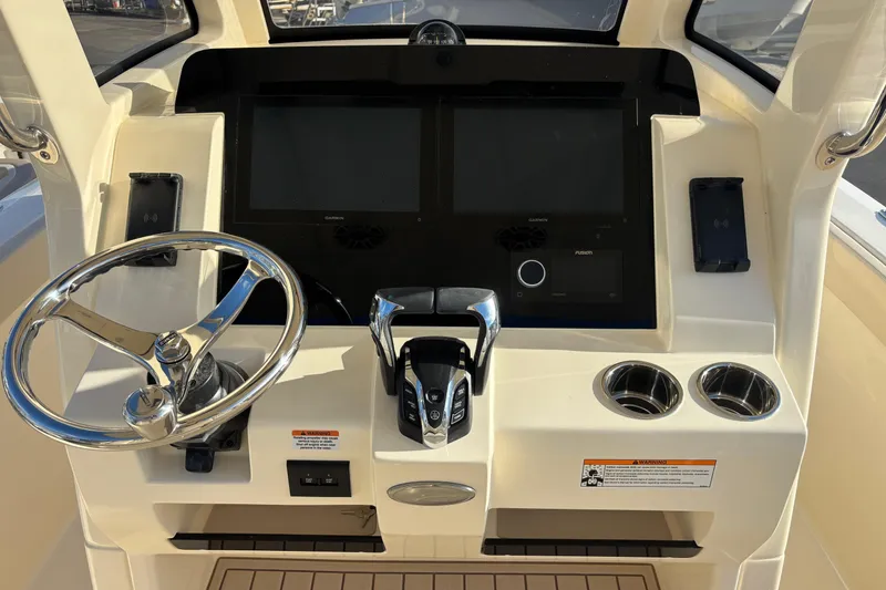 Slide: The Image of 2026 Scout 260 LXF boat dashboard with steering wheel, dual screens, and control panel. - 10