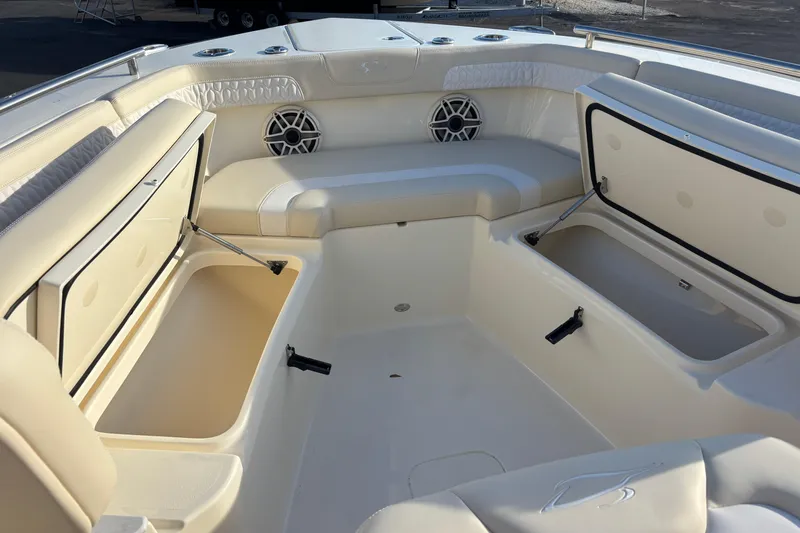Slide: The Image of 2026 Scout 260 LXF boat interior with open storage compartments and seating. - 14