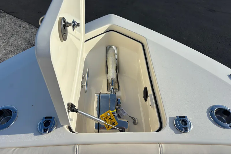 Slide: The Image of Open anchor compartment on 2026 Scout 260 LXF boat, showcasing storage and hardware. - 18