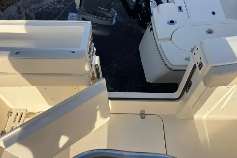 Slide: The Image of 2026 Scout 260 LXF boat interior with open hatch and seating area. - 21