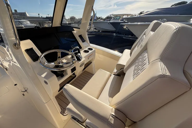 Slide: The Image of 2026 Scout 260 LXF boat interior with steering wheel and plush seating. - 9