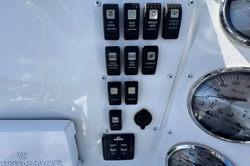 Slide: The Image of Control panel of a 2006 Polar 2300 CC boat with various switches and gauges. - 7