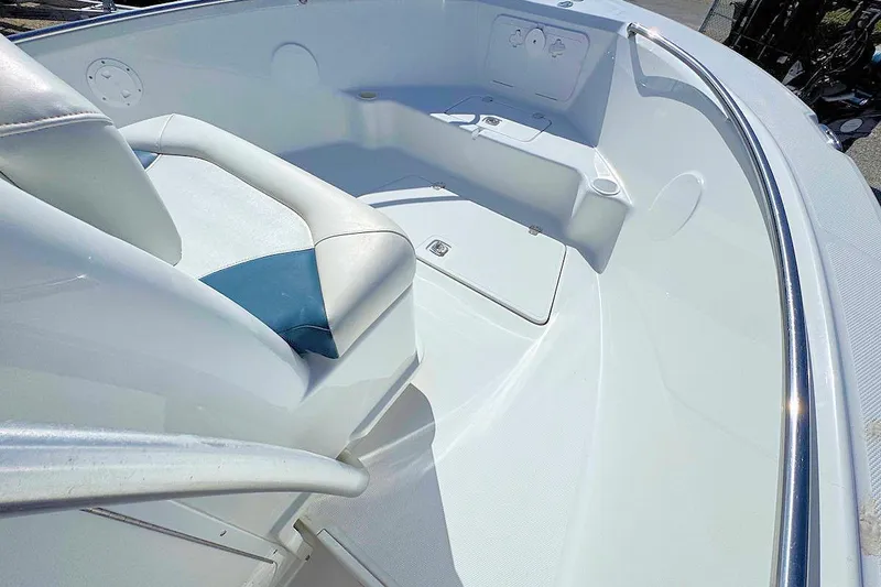 Slide: The Image of 2006 Polar 2300 CC boat interior with white seating and stainless steel railings. - 8