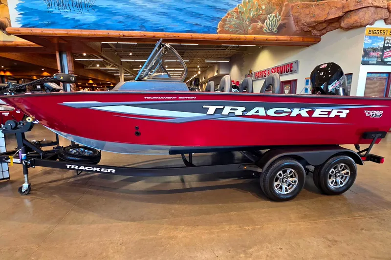 The Image of 2026 Tracker Targa V-19 Combo boat, red, on display indoors with trailer. - 1