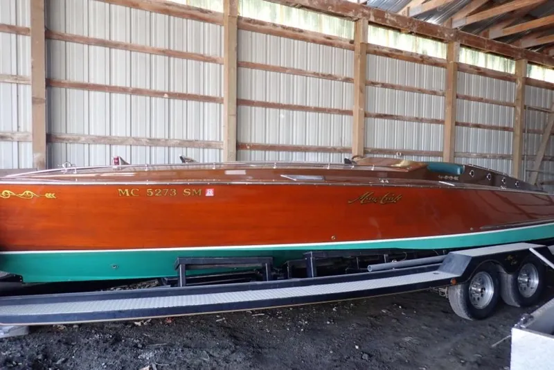 The Image of 2004 Mays Craft 25 Gentleman's Racer in storage, showcasing elegant wooden design. - 0