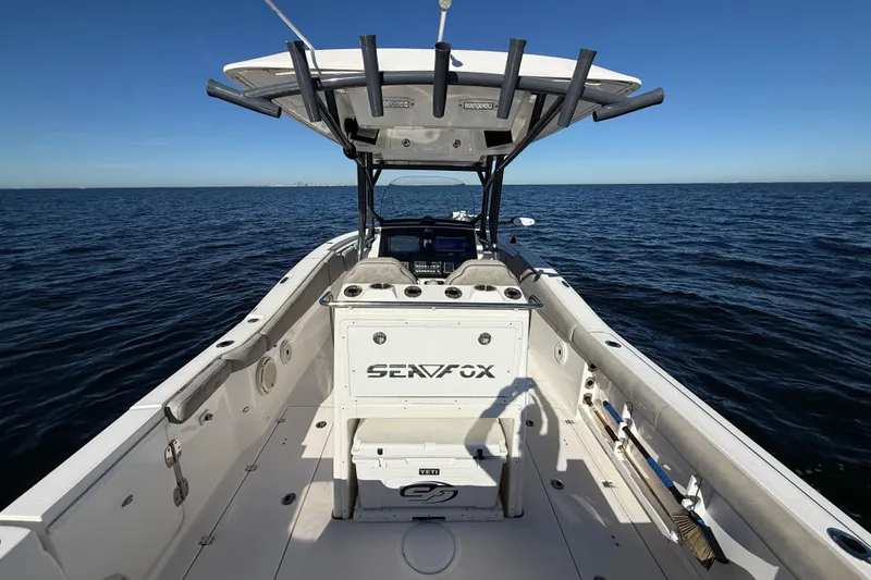Slide: The Image of 2021 Sea Fox 288 Commander boat on open water, showcasing spacious deck and helm. - 10