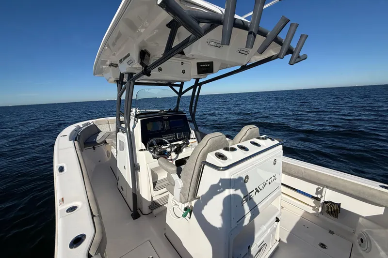 Slide: The Image of 2021 Sea Fox 288 Commander boat on open water, featuring modern helm and seating. - 14