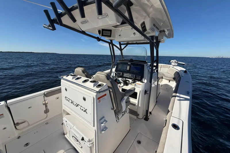 Slide: The Image of 2021 Sea Fox 288 Commander boat on open water, featuring modern helm and seating. - 16
