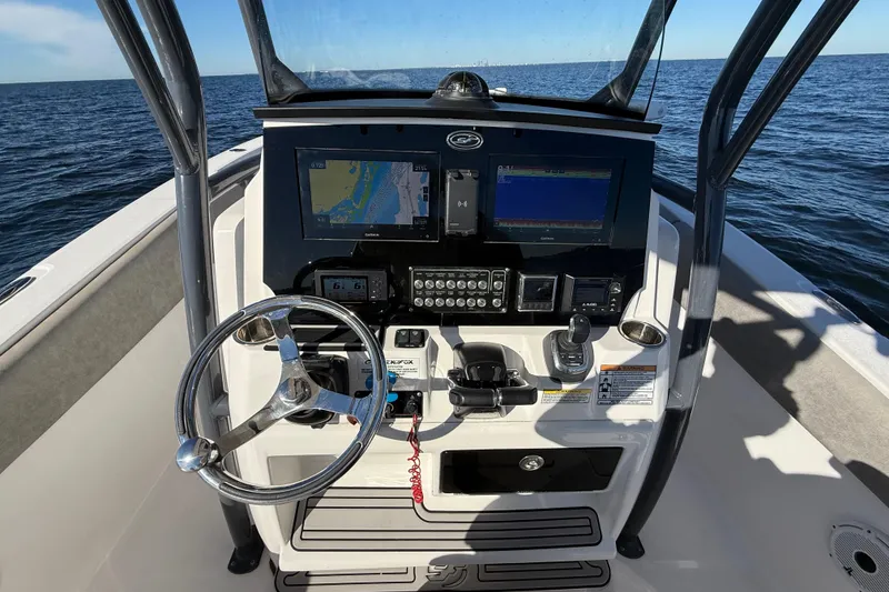 Slide: The Image of 2021 Sea Fox 288 Commander boat dashboard with navigation screens and steering wheel. - 18