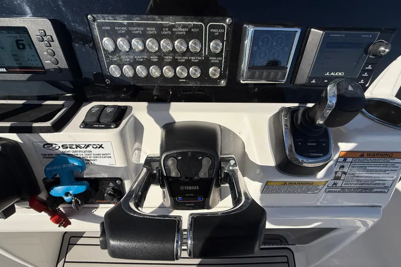 Slide: The Image of Control panel of a 2021 Sea Fox 288 Commander boat with Yamaha throttle and JL Audio system. - 26