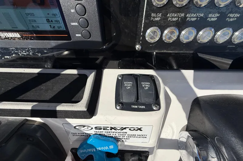 Slide: The Image of Control panel of a 2021 Sea Fox 288 Commander boat with trim tab switches. - 28