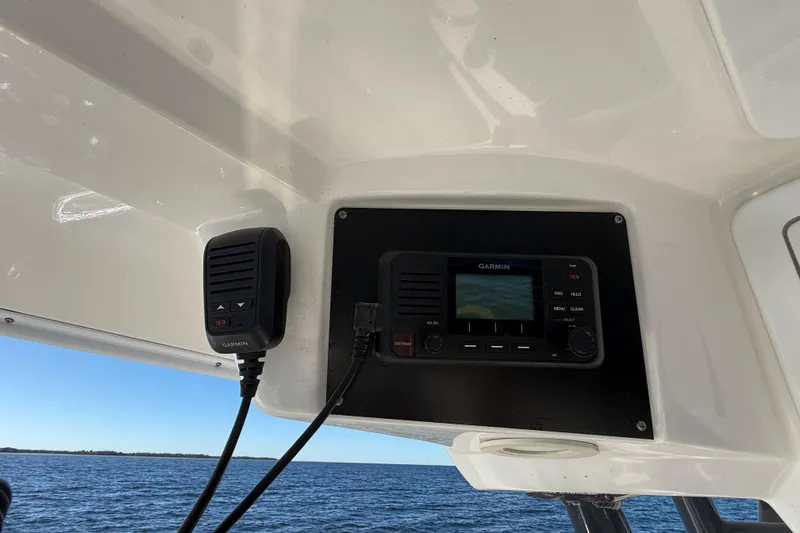 Slide: The Image of Garmin marine radio on 2021 Sea Fox 288 Commander boat, ocean view in background. - 30