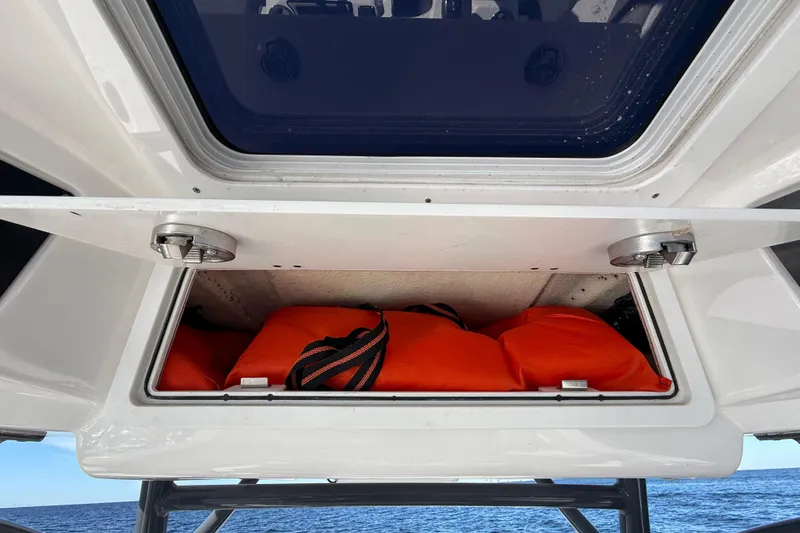 Slide: The Image of Storage compartment on 2021 Sea Fox 288 Commander boat with orange life jackets. - 32