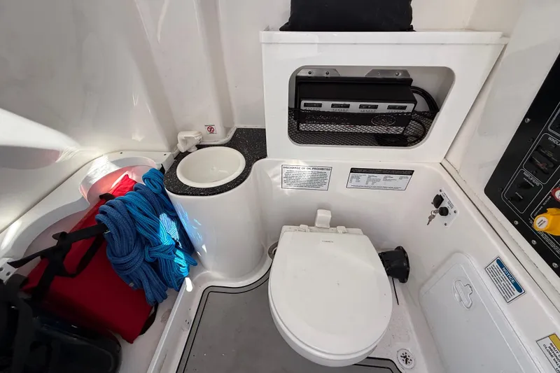 Slide: The Image of 2021 Sea Fox 288 Commander boat interior with toilet, storage, and control panel. - 38