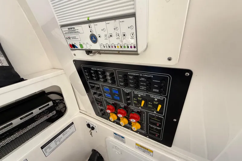 Slide: The Image of Control panel of a 2021 Sea Fox 288 Commander boat, featuring various circuit switches. - 41