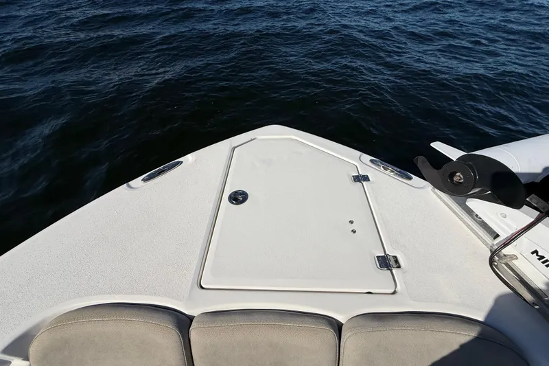 Slide: The Image of Bow of 2021 Sea Fox 288 Commander boat on water, featuring storage hatch and seating. - 58