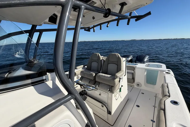 Slide: The Image of 2021 Sea Fox 288 Commander boat interior with seating, ocean view, and clear blue sky. - 72