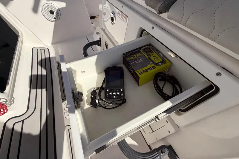 Slide: The Image of Open storage compartment on 2021 Sea Fox 288 Commander boat with electronic device and box. - 76
