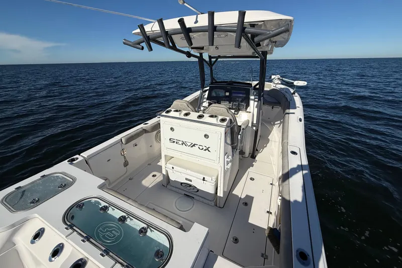 Slide: The Image of 2021 Sea Fox 288 Commander boat on open water, showcasing spacious deck and modern features. - 9