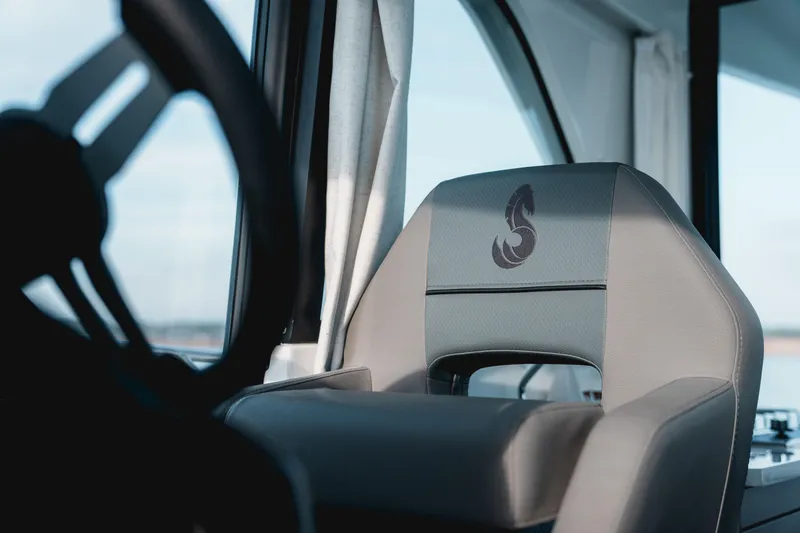Slide: The Image of 2026 Beneteau Antares 9 V2 helm seat with logo, showcasing luxury interior design. - 22