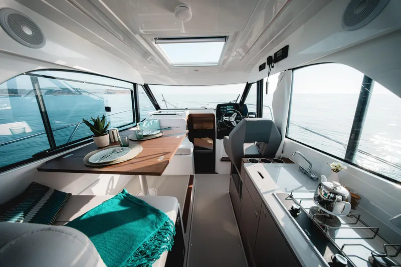 Slide: The Image of Interior of 2026 Beneteau Antares 9 V2 yacht with modern kitchen and seating area. - 17