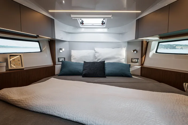 Slide: The Image of Luxurious cabin interior of 2026 Beneteau Antares 9 V2 with modern design and cozy bedding. - 26