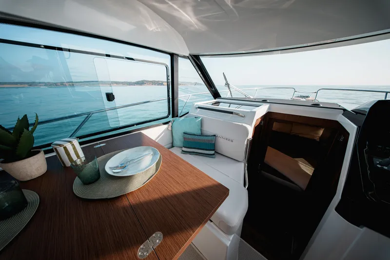 Slide: The Image of Interior of 2026 Beneteau Antares 9 V2 yacht with elegant dining setup and sea view. - 19