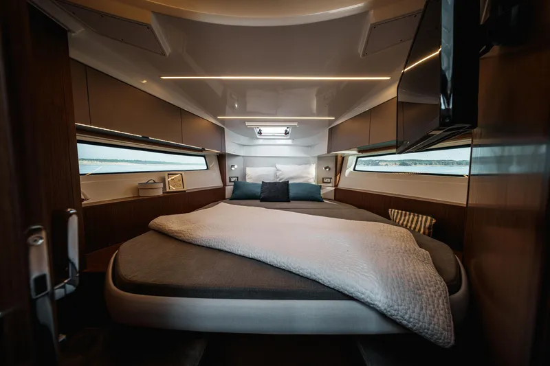 Slide: The Image of Luxurious cabin interior of 2026 Beneteau Antares 9 V2 with cozy bedding and modern design. - 25