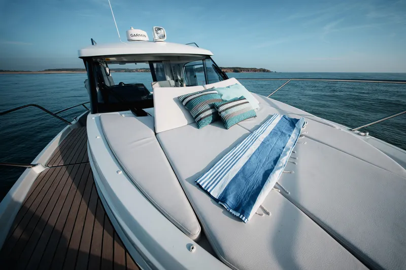 Slide: The Image of 2026 Beneteau Antares 9 V2 yacht with sunbathing deck, cushions, and ocean view. - 29