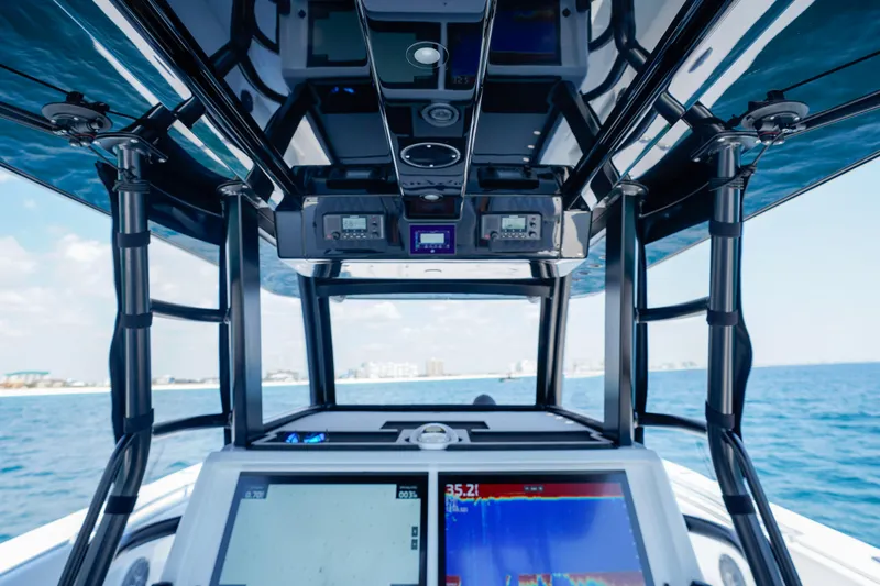 Slide: The Image of Interior view of 2026 Invincible 40 Catamaran cockpit with navigation screens and ocean backdrop. - 10