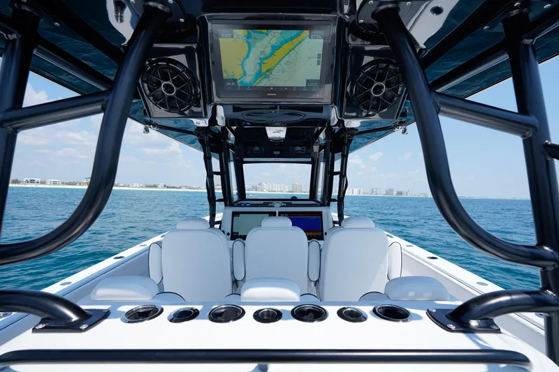 Slide: The Image of 2026 Invincible 40 Catamaran interior with navigation screens, ocean view, and white seating. - 11