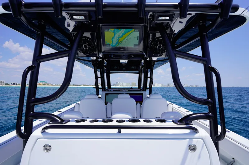 Slide: The Image of 2026 Invincible 40 Catamaran interior with navigation system, ocean view, and city skyline. - 12