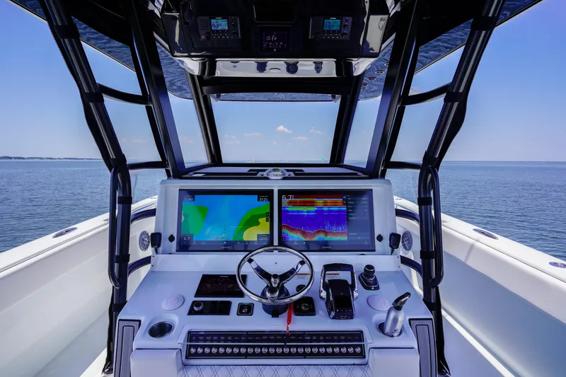 Slide: The Image of Helm of 2026 Invincible 40 Catamaran with advanced navigation systems on open water. - 13