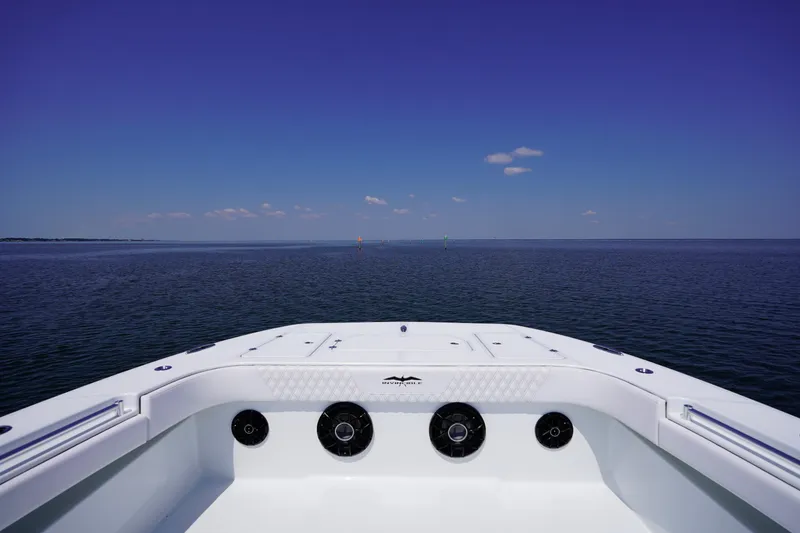 Slide: The Image of Bow view of 2026 Invincible 40 Catamaran on open sea under clear blue sky. - 20
