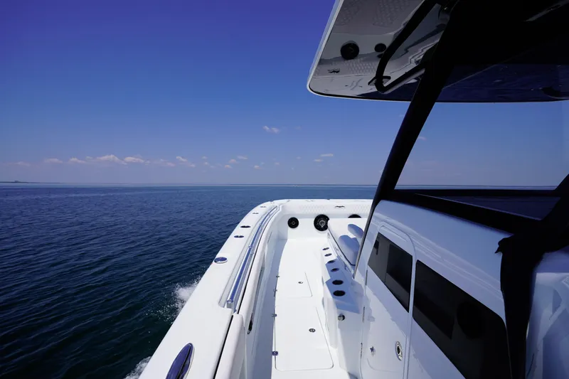 Slide: The Image of 2026 Invincible 40 Catamaran cruising on open sea under clear blue sky. - 21