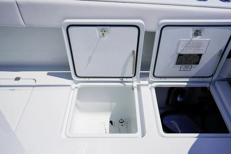 Slide: The Image of Open storage compartments on a 2026 Invincible 40 Catamaran boat deck. - 23
