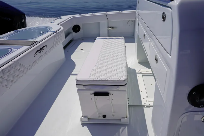 Slide: The Image of 2026 Invincible 40 Catamaran interior with cushioned seating and storage compartments. - 25