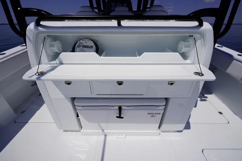 Slide: The Image of 2026 Invincible 40 Catamaran fishing station with storage drawers and cooler. - 26
