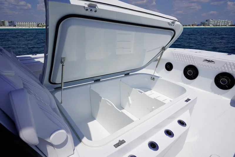 Slide: The Image of Open storage compartment on 2026 Invincible 40 Catamaran, featuring sleek design and ocean backdrop. - 29
