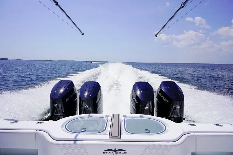 Slide: The Image of 2026 Invincible 40 Catamaran with four Mercury engines cruising on open water. - 30