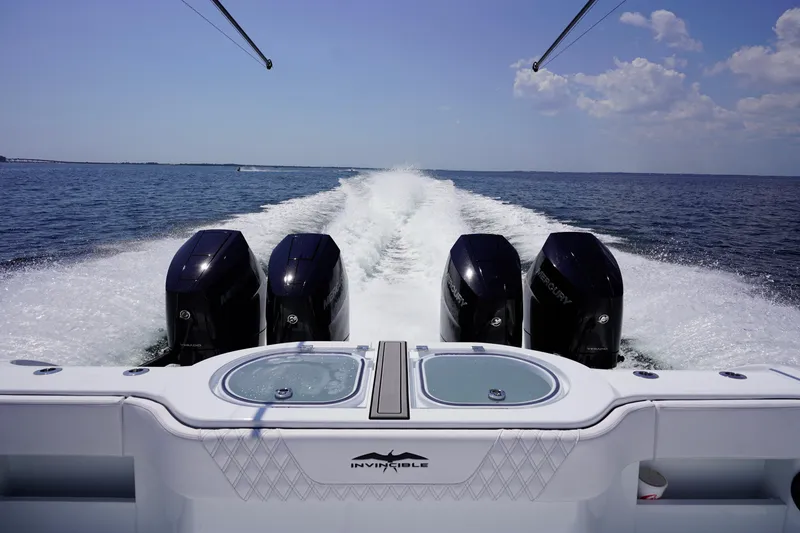 Slide: The Image of 2026 Invincible 40 Catamaran with four powerful outboard motors cruising on open water. - 31